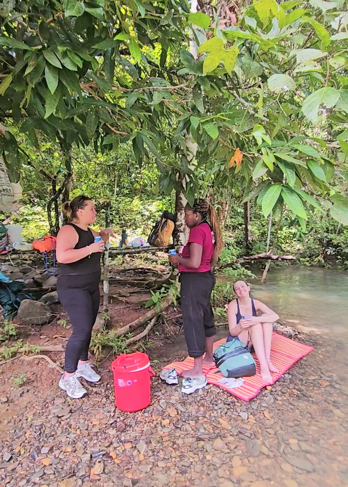 Guests relaxing at the river camp after the trek